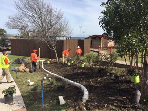 Company Volunteers to Green Up Sports Field